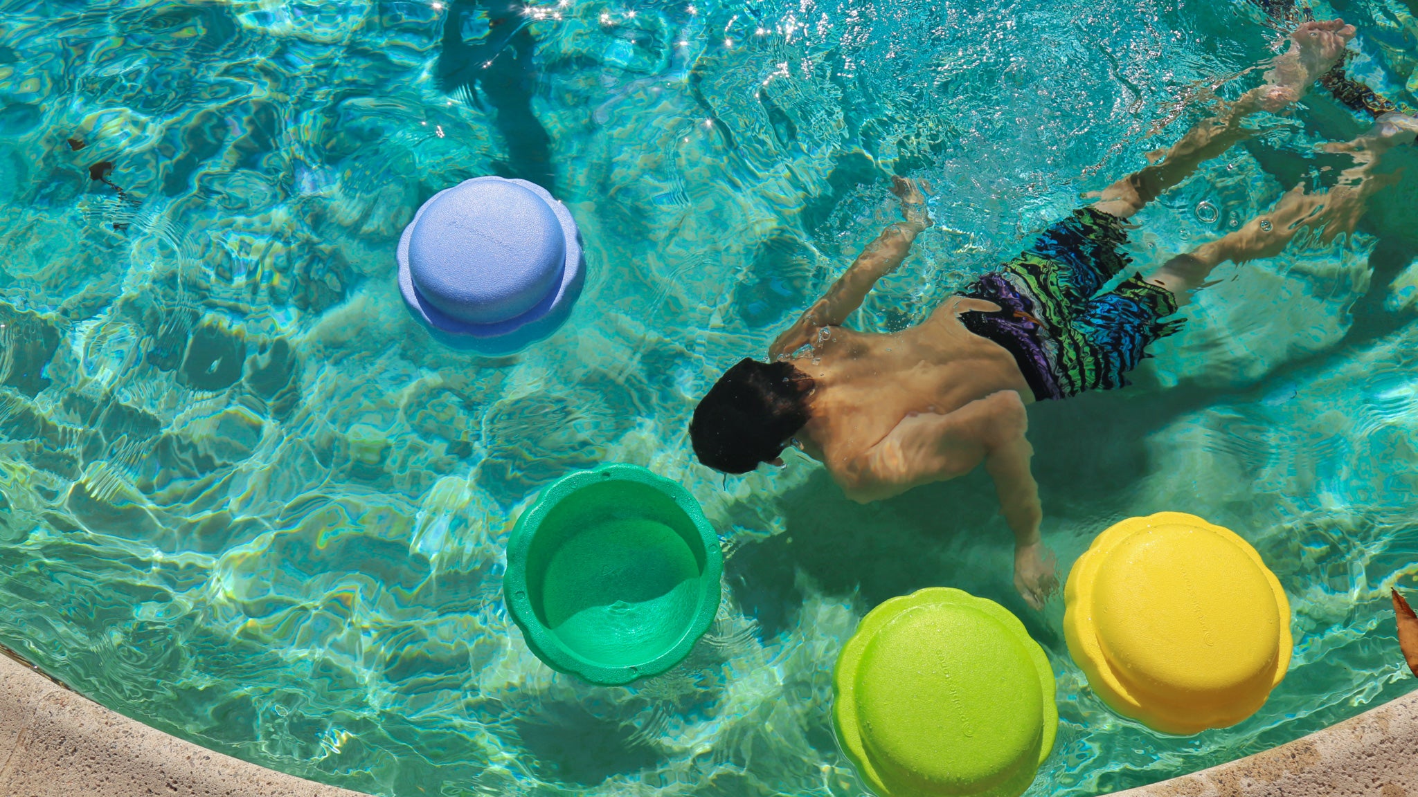 foam stacking stones in a pool with a child