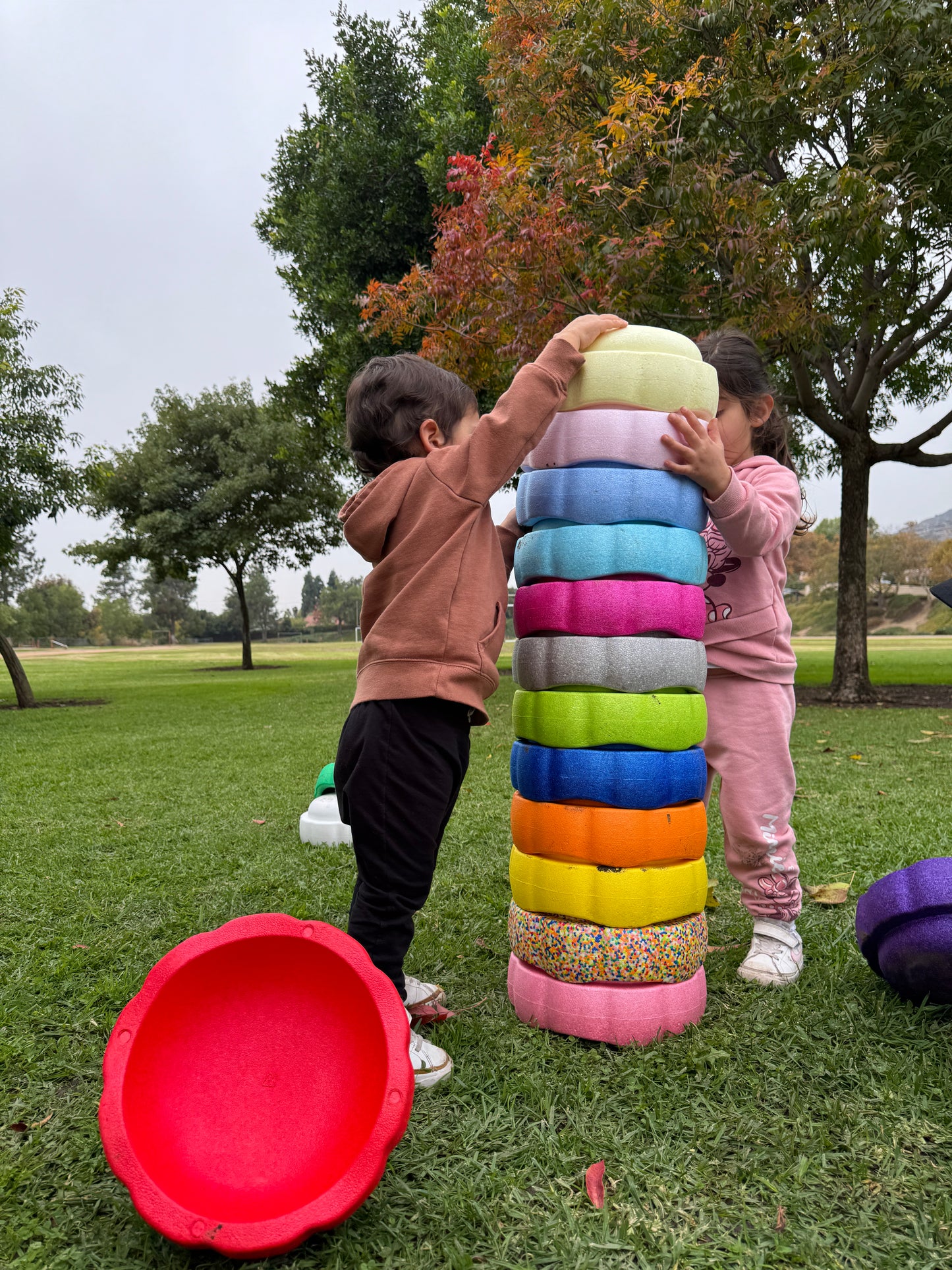 Colorful fun versatile stacking stones, stepping stones made out of lightweight Expended Polypropylene foam for kids for movement, open ended play, active learning, creativity, exercise, social development, motor development, cognitive development. can be combined with the balance board