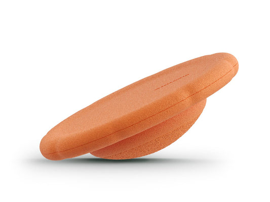 orange balance board for workout, exercise, movement, and active play for kids. Used for yoga and physical therapy. Raised edge for extra support. Can be combined with the stacking stones. made of 100% Expended Polypropylene.